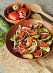 Fresh salad with tomatoes and cucumbers.	
