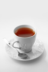 Close up view of white porcelain cup of tea on white background
