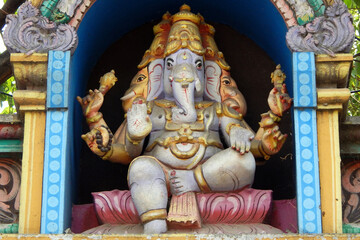 view of Indian Hindu God Ganesha statue on the temple tower or gopuram