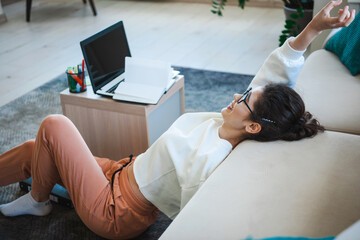 Woman saying yes on the floor after finishing homework. Lucky person. Educational concept photo of...