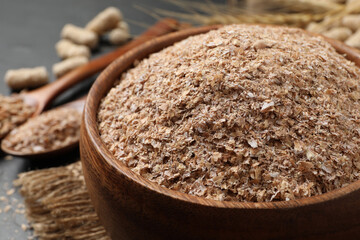 Wheat bran in bowl on table, closeup