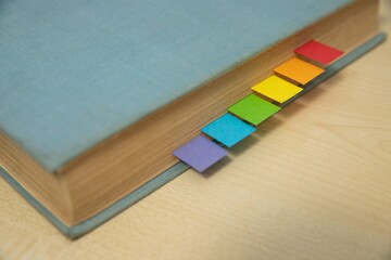 Book with LGBTQ+ color labels on desk