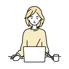 デスクで座ってPCを使っているリモートワークの女性