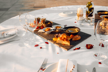 Photo of a table with a white tablecloth on which delicious food