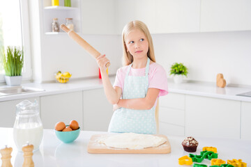 Obraz na płótnie Canvas Photo of minded young thoughtful little girl look hold rolling pin make recipe cookie indoors inside house kitchen