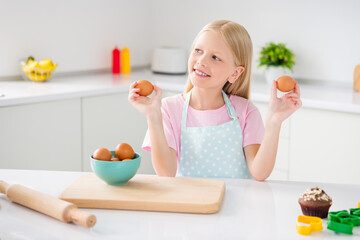 Photo of happy positive dreamy girl look hold hands food eggs cook smile indoors inside house home...