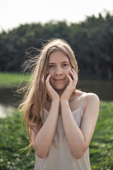 Portrait of Young caucasian woman. Beauty Girl without Makeup in White dress. Natural Skin Beauty. Long blond hair. Natural beauty without make-up 