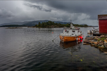Fototapeta premium A fishing boat is waiting for good weather at the pier.