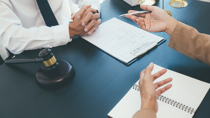 Judge gavel with Justice lawyers having team meeting at law firm background. Concepts of Law and...