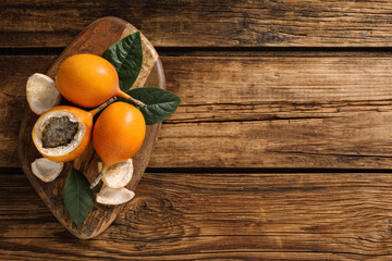 Delicious ripe granadillas on wooden table, top view. Space for text