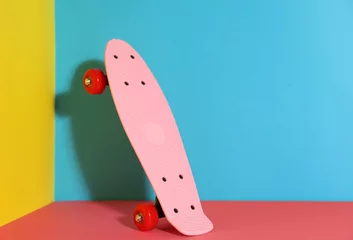 Zelfklevend Fotobehang Pink skateboard on color background. Space for text © New Africa