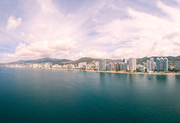 Beautiful view of the beach, aerial view of the sea, acapulco beach seen from above. Travel and vacation concept. Colorful sunset on the beach. Aerial photography.