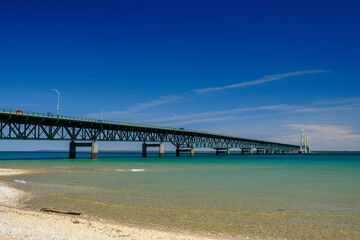 The colorful and clear waters of the straits of Mackinac and the Mackinac Bridge connecting the Upper and Lower Peninsula of Michigan