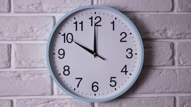 Classic analog clock pointing at nine fifty five, isolated on white background. Office round clock shows five to ten. Time concept