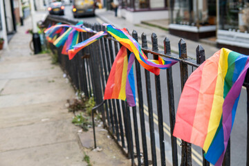 Group of LGTB flags waving on a balcony in the streets of UK.