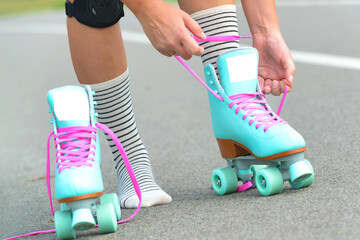 The woman is putting on roller skates
