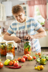 Woman in the kitchen makes pickles