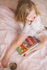 a little girl reads a book a children's bible