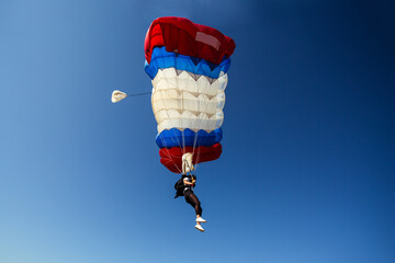 Parachute in the sky. Skydiver is flying a parachute in the blue sky.