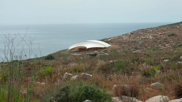 Distant View Of Mnajdra Megalithic Temple Complex At The Mediterranean Coast Of Malta. wide shot