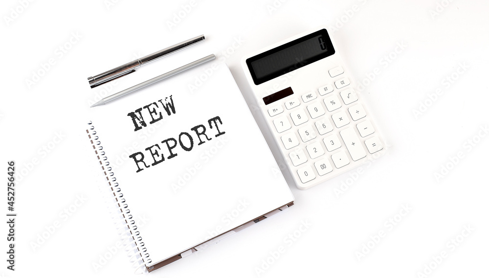 Aufkleber notepad with text new report with calculator and pen. white background. business concept