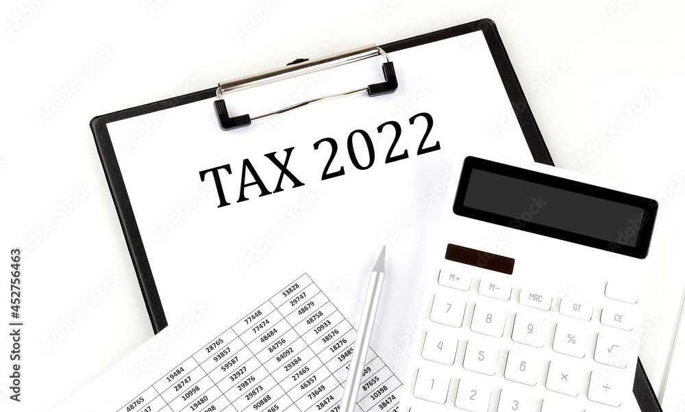 Poster tax 2022 text on folder with chart and calculator on white background