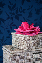 Natural gift box with a pink bow or ribbon used as decoration against a dark wall. High quality...