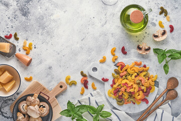 Fototapeta na wymiar Pasta. italian pasta. Insalata di pasta and vegetables cooking ingredients, cheese, mushrooms and basil on old stone background. Italian food cooking ingredients. Top view with copy space.