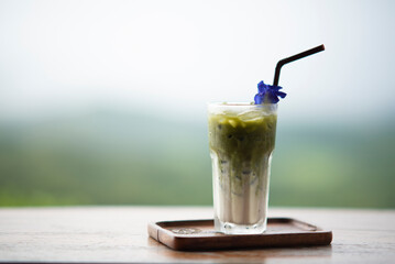 iced green tea on mountain blur background.