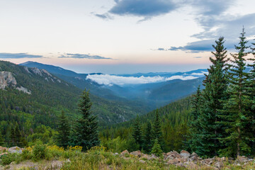 Mountain panorama over the clouds sunset along  Squa Pass Road near Echo Lake Park, Colorado