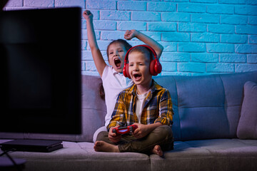 children playing video game with game console