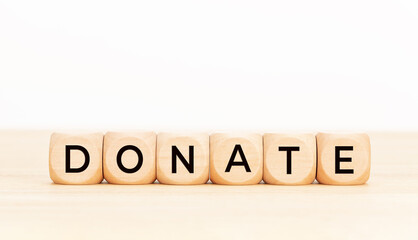 Donation word on wooden block shape. Copy space. White background