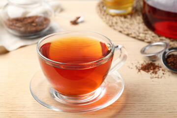 Freshly brewed rooibos tea on wooden table