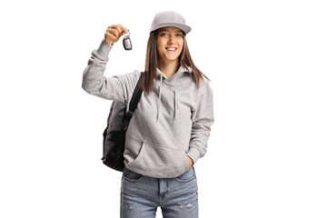 Teen female holding a car key and smiling