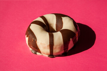 Top view of a donut on pink background