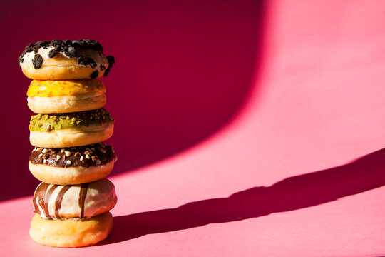Stack of donuts on pink background