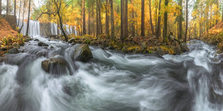 Waterfalls and river with fast aqua streams in mountains