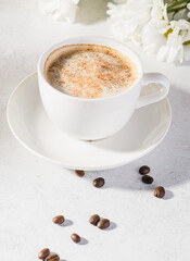 Obraz na płótnie Canvas coffee in a mug with milk and cinnamon