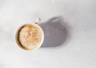 coffee in a mug with milk and cinnamon