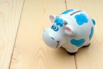 piggy bank cow on wooden background