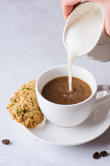 coffee in a mug with milk and cinnamon