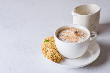 coffee in a mug with milk and cinnamon