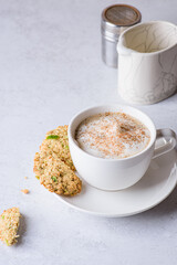 coffee in a mug with milk and cinnamon