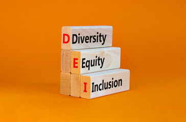 Naklejka premium DEI, Diversity, equity, inclusion symbol. Wooden blocks with words DEI, diversity, equity, inclusion on beautiful orange background. Business, DEI, diversity, equity, inclusion concept.