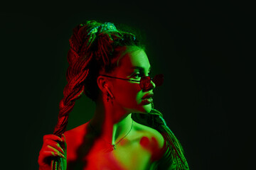 young woman with dreadlocks in red sunglasses