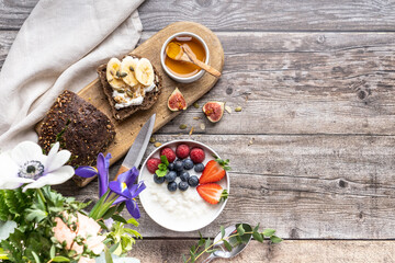  Beautifully served table for breakfast with many delicacies, cheeses, salami, pastries, orange juice, tea and coffee.