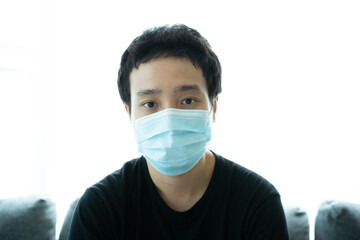 Asian young man wearing a protective face mask portrait.