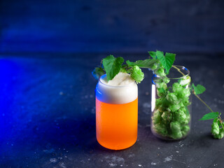 glass of craft beer on a dark table with a blue backlight. New England IPA