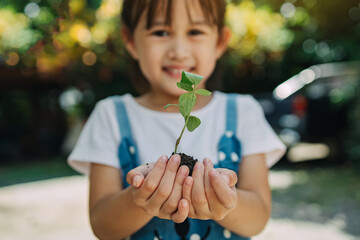 Cute kid planting a tree for help to prevent global warming or climate change and save the earth....