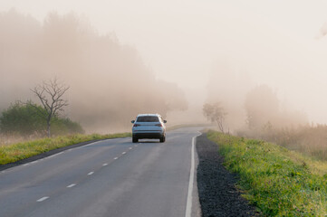 Beautiful landscape overlooking the road in the fog, car